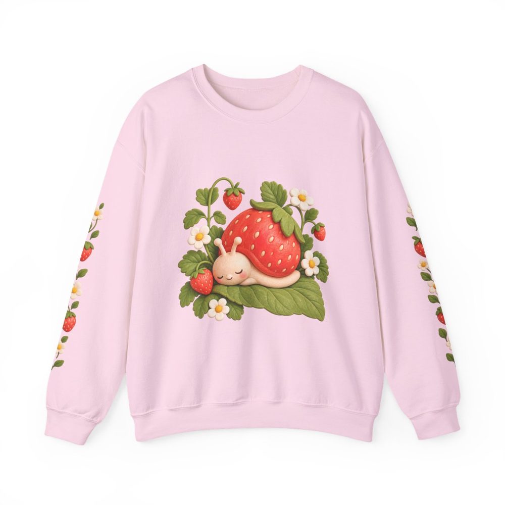 Strawberry Snail crewneck sweatshirt in light pink, a sleepy snail with a strawberry for a shell among leaves and blossoms on the front with matching prints down both sleeves