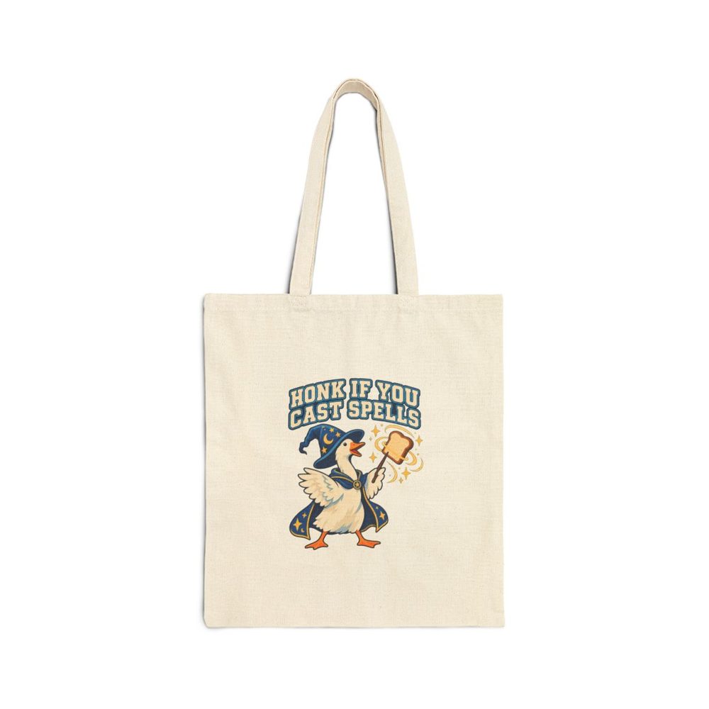 Wizard Goose tote bag in natural cotton canvas, printed with a white goose in a starry blue wizard robe and hat waving a slice of toast like a wand, under the words Honk If You Cast Spells